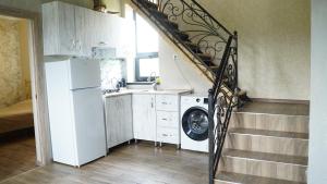 a kitchen with a staircase with a washing machine at Jermuk garden in Kechʼut