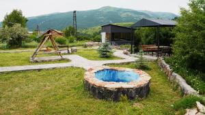 a garden with a fire pit made out of logs at Jermuk garden in Kechʼut