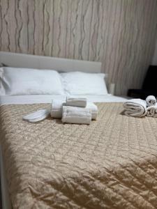 a bed with two towels on top of it at Matera Central Nest in Matera