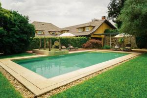 a swimming pool in the yard of a house at Estrepão House in Moreira de Conegos