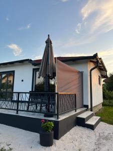 a house with a patio with an umbrella at Villa Noor Visoko in Visoko