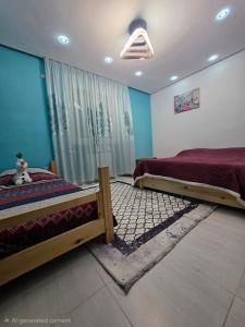 a bedroom with two beds and a window at Ayem house in Souidania