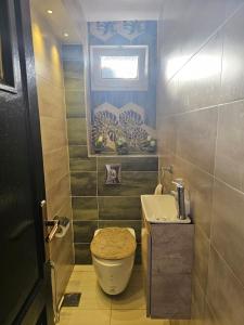 a bathroom with a toilet and a sink at Ayem house in Souidania