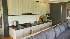 a kitchen with a row of blue chairs and a counter at Jermuk garden in Kechʼut +30 photos