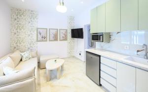 a kitchen and living room with a couch and a table at Korina Suites in Perea