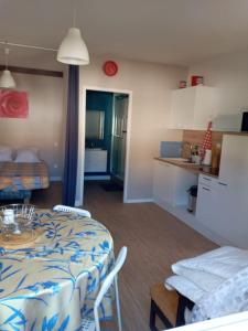 a kitchen and a room with a table and a kitchen and a room with at Studio à louer in Vic-Fezensac
