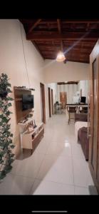 a large living room with a couch and a tv at Chácara Marias Da Serra in Araruna