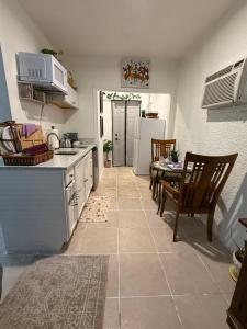 a kitchen and dining room with a table and chairs at Serenity Garden Studio with Pool in Naples