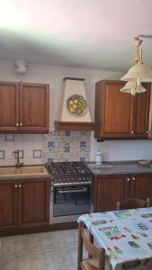 a kitchen with a stove and a plate on the wall at Villa daniela in Taormina