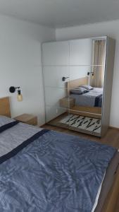 a bedroom with a large mirror and a bed at Mugav mereäärne korter in Orissaare