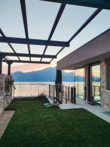 a patio with a view of the ocean from a house at Villa Horizon in Torri del Benaco