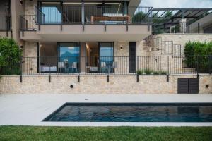 a house with a swimming pool in front of a house at Villa Horizon in Torri del Benaco