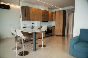 a kitchen with a table and chairs and a blue couch at Villa Horizon in Torri del Benaco