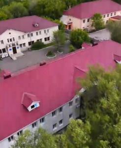 an aerial view of a building with pink paint at Inju in Temirtaū
