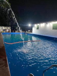 a pool of water with a person jumping into it at Complejo el cordobes in Albardón
