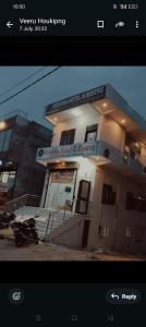 a building with a motorcycle parked in front of it at Krishna hotel and restro in Jaipur