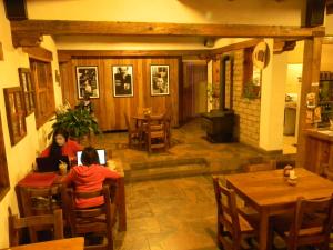 two people sitting at tables in a restaurant at La Troje de Adobe in Creel