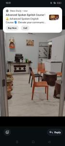 a room with a table and a chair in it at Krishna hotel and restro in Jaipur