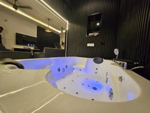 a large white bath tub in a room at The High View in Mohali