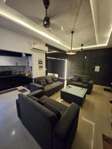 a living room with couches and a table at The High View in Mohali