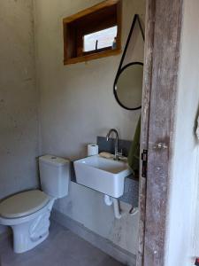 a bathroom with a toilet and a sink at Chalé Araucárias-Recanto dos pássaros in Cambuí +53 photos