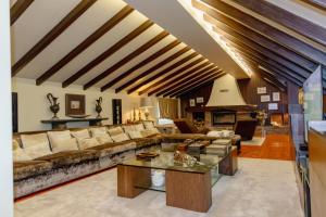 a living room with a couch and a table at Estrepão House in Moreira de Conegos