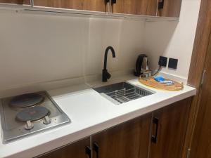 a small kitchen with a sink and a stove at شقق لولو in Hail