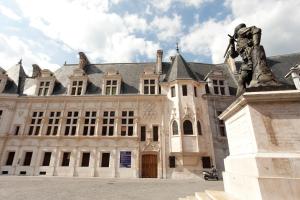 a statue of a man standing in front of a building at Historic Centre Studio, St-André & Bastille view! in Grenoble