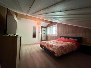 a bedroom with a large bed in a room at Chalet du paradis in La Bresse