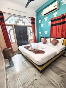 a bedroom with a large bed in a room at Hotel Lotus in kolkata