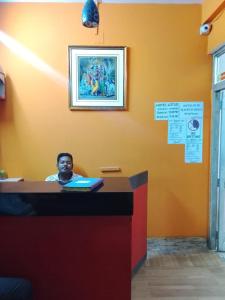 a man sitting at a desk with a laptop at Hotel Lotus in kolkata