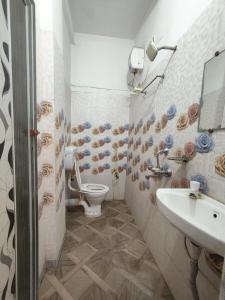 a bathroom with a toilet and a sink at Hotel Lotus in kolkata