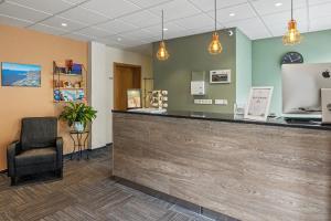 a waiting room with a counter and a chair at Hotel West in Patreksfjörður