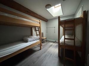 a bedroom with two bunk beds and a skylight at L'Embaradere in Laruns