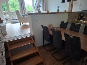 a dining room with a wooden table and chairs at EifelAuszeit in Simmerath