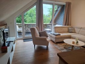 a living room with a couch and a chair at EifelAuszeit in Simmerath