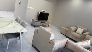 a living room with couches and a flat screen tv at الصفا in Jeddah