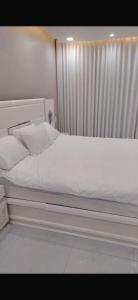 a bed with white sheets and pillows in a bedroom at الصفا in Jeddah +2 photos