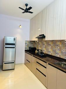 a kitchen with a stainless steel refrigerator at Verdant vista Goa in Cunchelim
