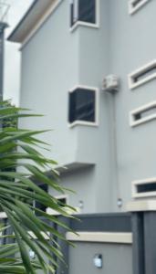a plant in front of a white building at FOURTOWERShotel in Ijoko Lemode