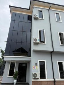 a white building with windows and speakers on it at FOURTOWERShotel in Ijoko Lemode