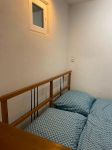 a bedroom with a bed and a small window at Ubytování Adina in Velké Pavlovice