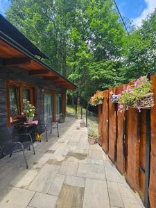 a patio with potted plants on a wooden cabin at Chatka Bystrá jacuzzi,stars,river in Bystrá +7 photos