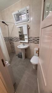 a small bathroom with a sink and a toilet at Studio Prestige - 10min de ParkMall in Sétif