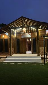 a house with a porch with lights on at شالية الكوخ in Salalah