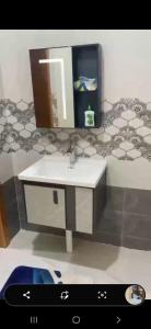 a model of a bathroom with a sink and a mirror at المربع سويت in Al Qarhāʼ