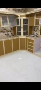 a kitchen with white cabinets and a white counter top at المربع سويت in Al Qarhāʼ