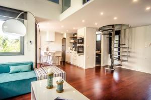 a living room with a blue couch and a table at Pleiades Boutique Villas in Kriopigi
