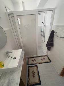 a bathroom with a shower and a sink at Talia in Bejaïa