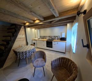 a kitchen and dining room with a table and chairs at Le Bâti in Servoz +4 photos